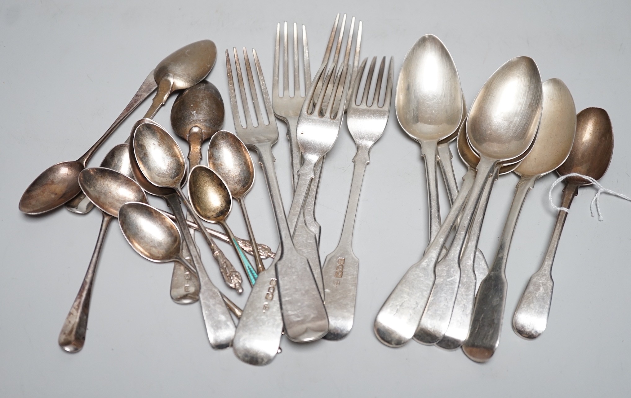 A small quantity of George III and later silver fiddle pattern and other cutlery, various dates and makers, 20.6oz.